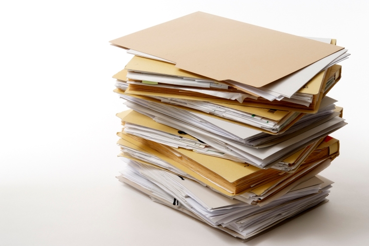 Isolated shot of stacked file folders on white background