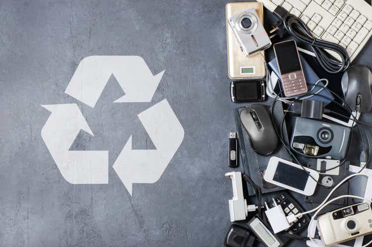 Old electronic devices on a dark background. The concept of recycling and disposal of electronic waste.