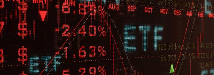 ETF investment, Exchange traded funds. Close-up red illuminated trading screen with financial figures, quotes and percentages.