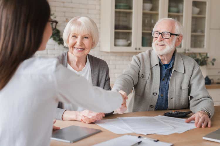 Happy aged aged elder grandparents family mates clients signs financial insurance, pension, startup, dealing handshake supplier lawyer, statement pinch customers connected finance contract, slope manager