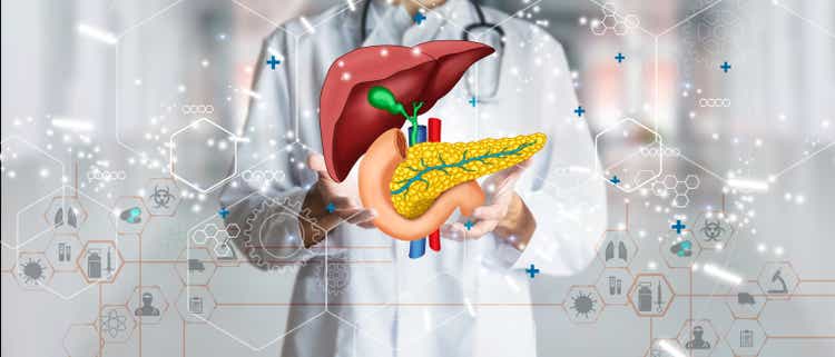 Doctor holding hologram of human liver system as a concept of health and well-being. Medical future technology and innovative concept. Mixed Media