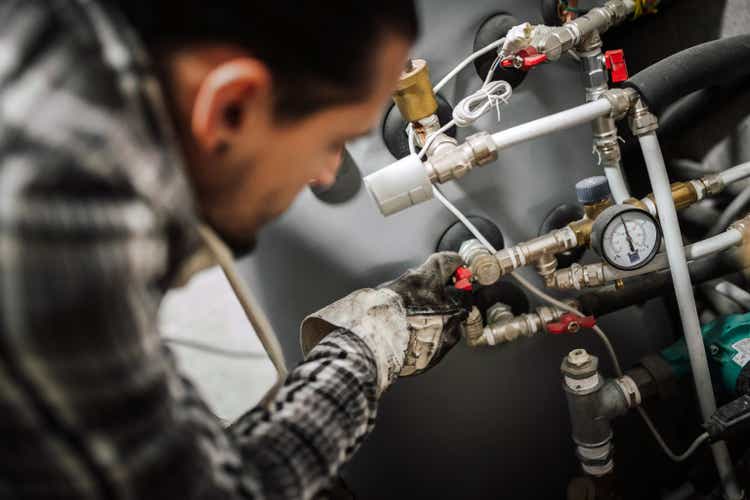 Heating engineer fixing modern heating system.