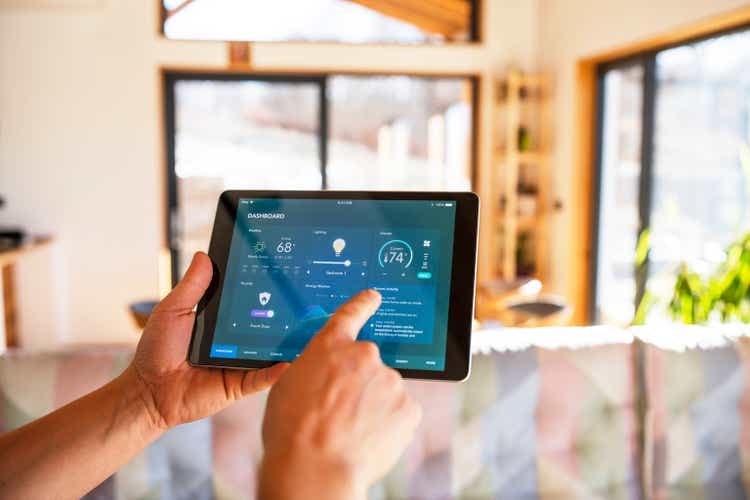 Man using tablet with smart home control functions at home.