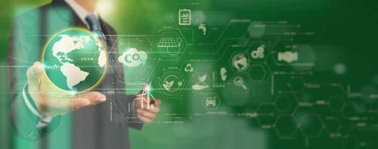 Businessman working virtual globe modern computer to reduce CO2 emissions carbon footprint climate change to limit global warming.Sustainable development and innovation green business concept.
