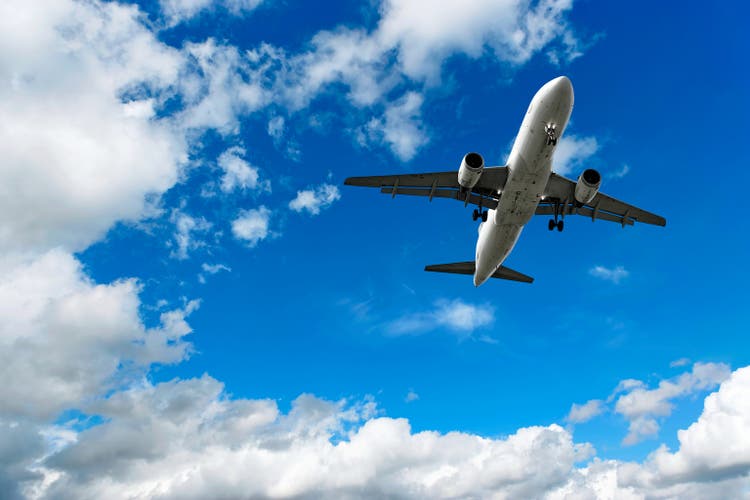 jet airplane landing in bright sky