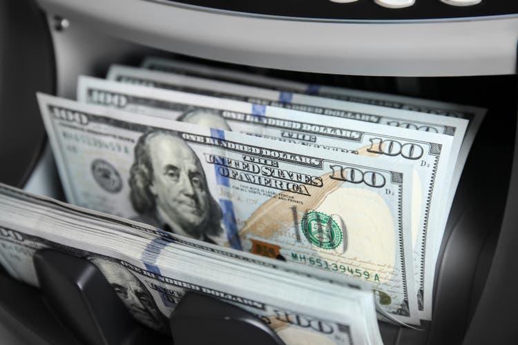 Modern electronic bill counter with money, closeup