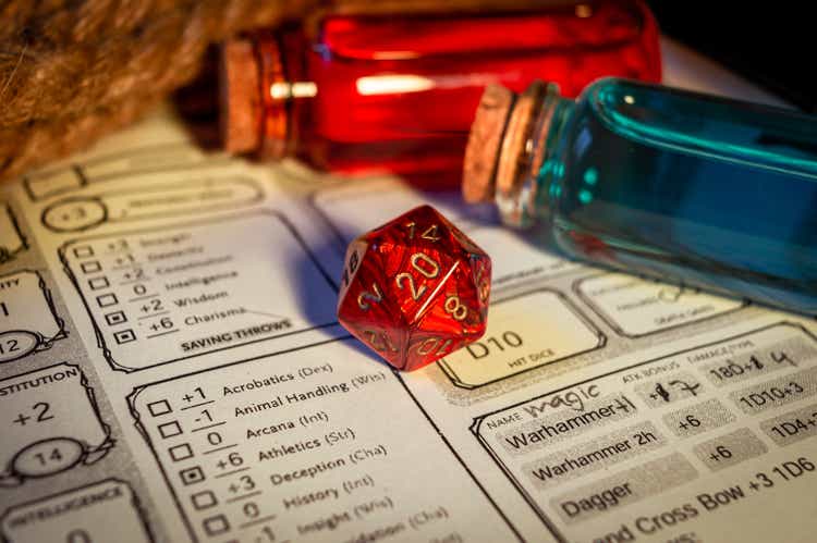 Close-up of a red d20 on a character sheet