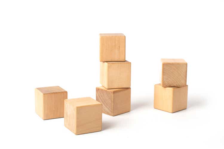 Tower of three wooden cubes, isolated on white