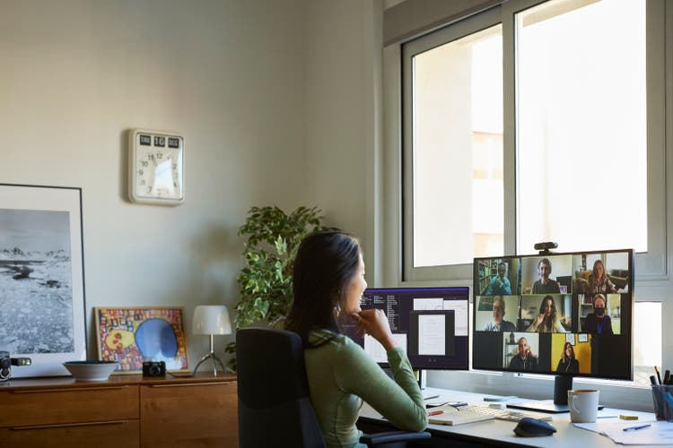 Colleagues discussing on video call at home office