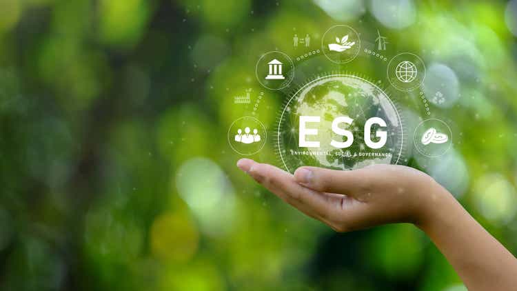 ESG icon concept. Environment in renewable hands. Nature, earth, society and governance SG in sustainable business on networked connections on green background. environmental icon