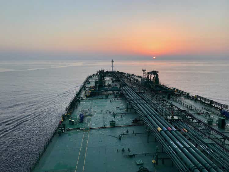 A tanker ship is underway at sea in the evening, view from the bridge wings