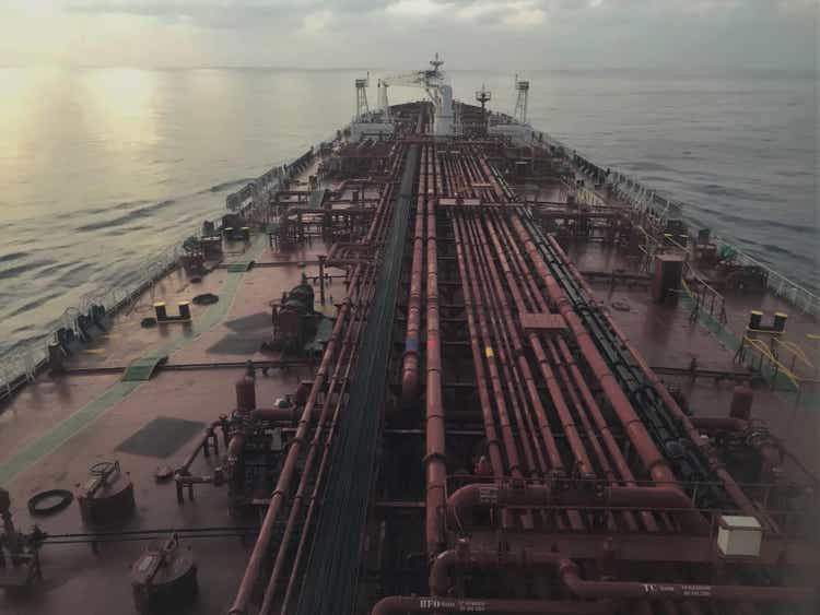 A tanker ship is underway at sea in the evening, view from the bridge wings