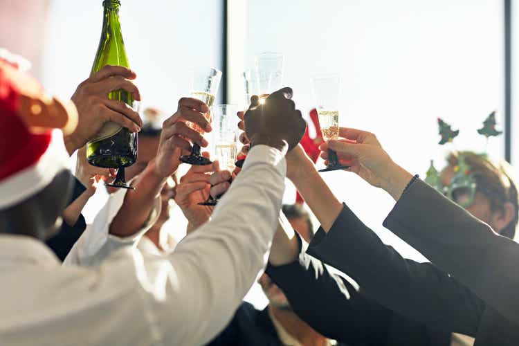 Celebratory toast with champagne at office Christmas party
