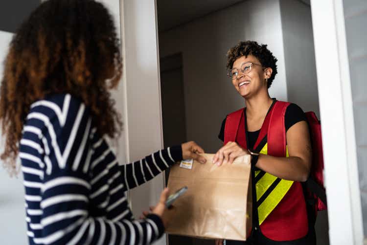 Woman receiving delivery at home