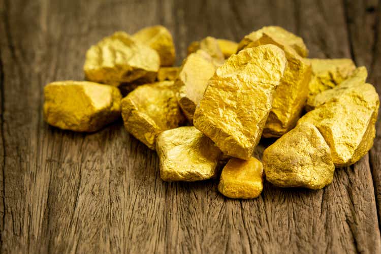 The pure gold ore obtained from the mine was placed on an old wooden floor.