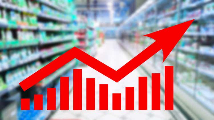 Red growing up arrow on abstract blur supermarket shelf background. Bar charts and graphs. Rising consumer prices. Inflation concept. Retail industry. Finance and Economy. Stock Market. Store. CPI