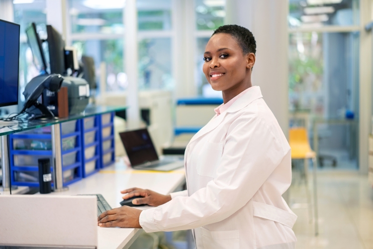 Woman scientist working on computer in a science lab