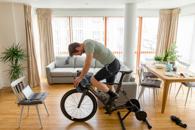 Man working out on his indoors cycling turbo trainer