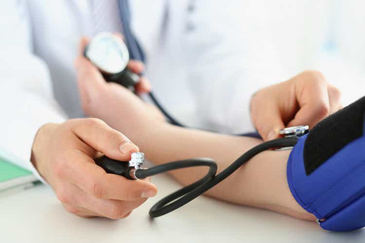 Doctor check blood pressure of patient in clinic, risk of hypertension, prevent disease
