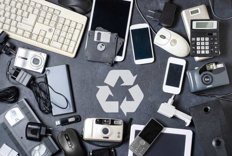 Old electronic devices on a dark background. The concept of recycling and disposal of electronic waste.