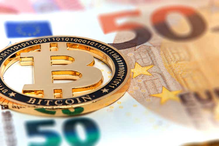 New Golden bitcoin on fifty euro banknotes background. Bitcoin crypto currency, Blockchain technology, digital money, Mining concept, bitcoin on 50 euro bill