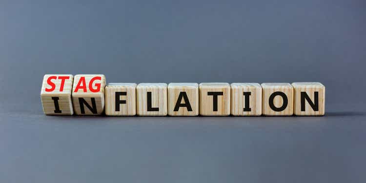 Stagflation or inflation symbol.  Turned wooden cubes and changed the concept word inflation to stagflation.  Beautiful gray table gray background, copy space.  Business stagflation or inflation concept.