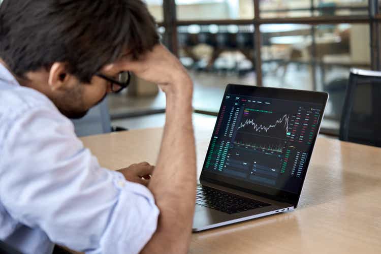 Stressed businessman analysis stock market trading falls.