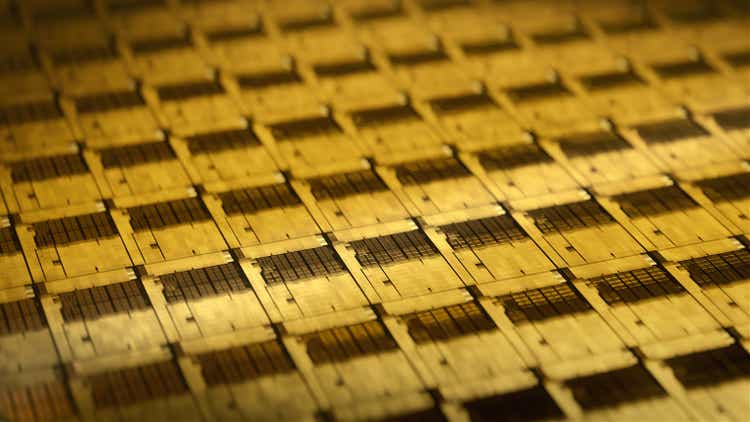 Macro Shot of Silicon Wafer in Yellow light at Advanced Semiconductor Foundry, that produces Computer Chips.