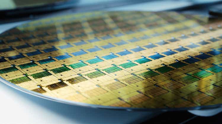 Close-up Shot of Silicon Wafer in Bright light at Advanced Semiconductor Foundry, that produces Computer Chips.