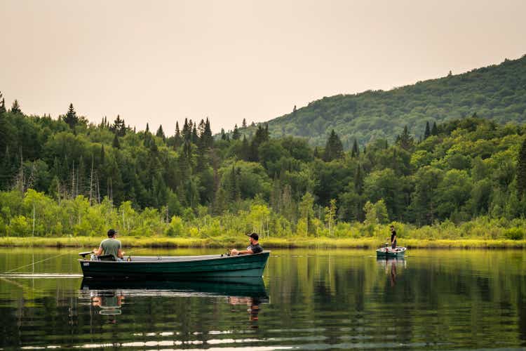 Three men fishing on a lake in Quebec.