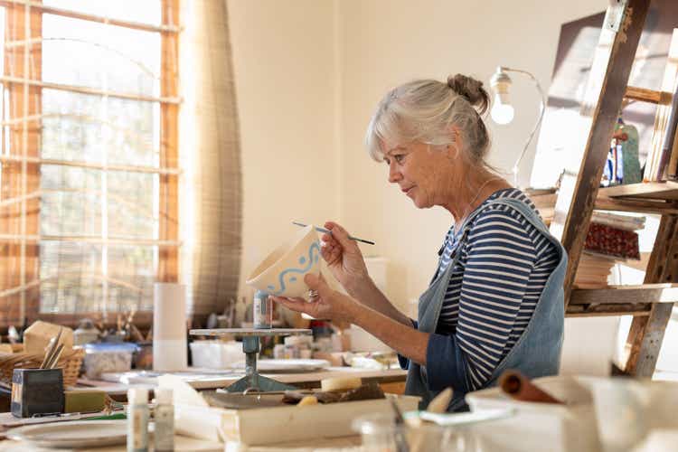 Female artist making a clay bowl in her pottery studio