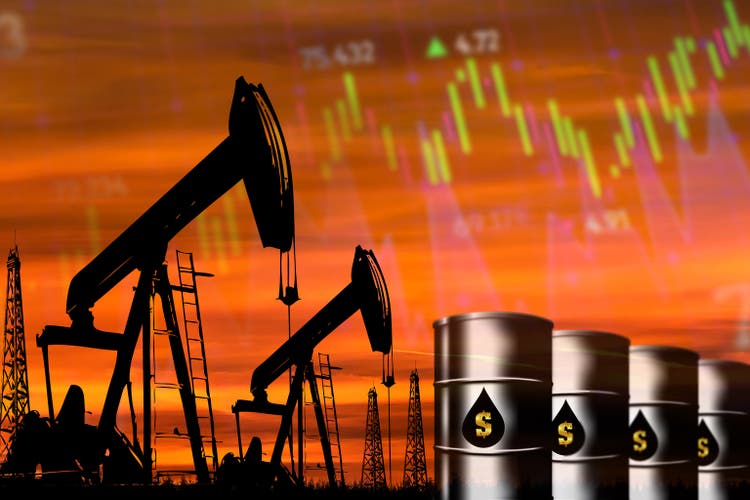 Oil field, oil pump jack in the sunset. Falling crude oil prices.