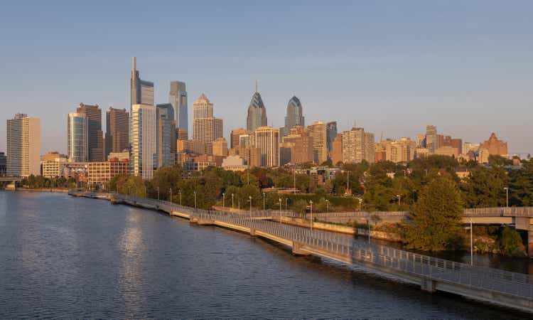 Philadelphia Downtown skyline with the Schuylkill river. Beautiful Sunset Light. Schuylkill River Trail in Background. City skyline glows under the beautiful sunset light