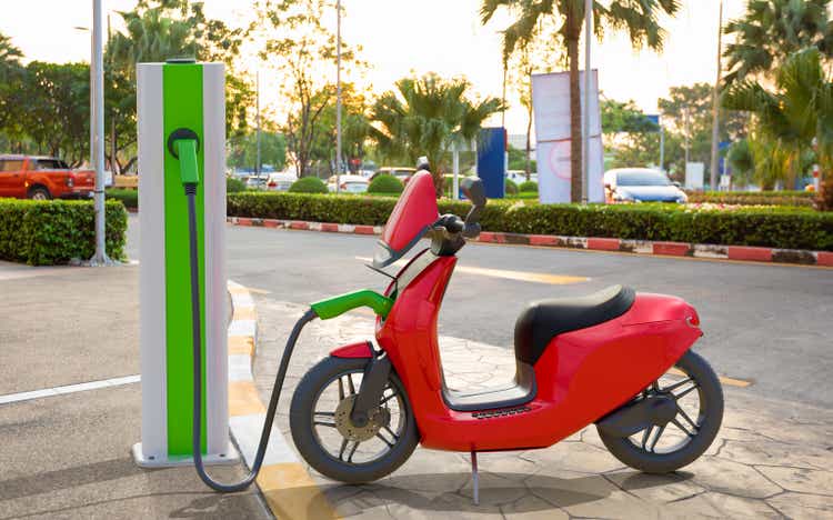 An electric scooter charging at power station