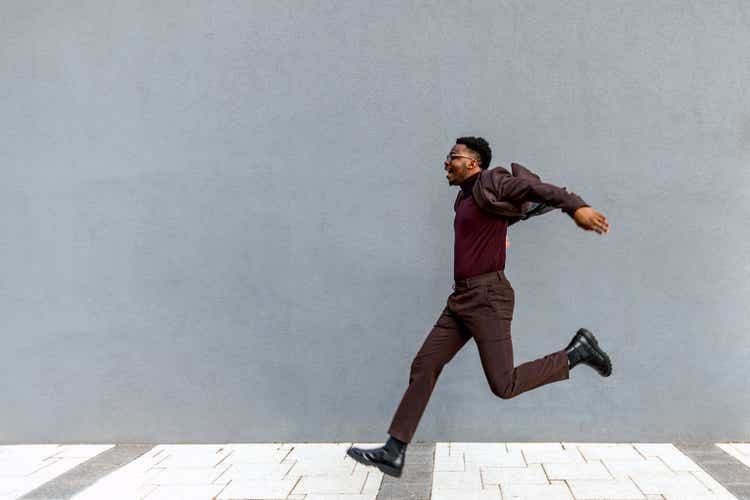 A male businessman jumping in the city
