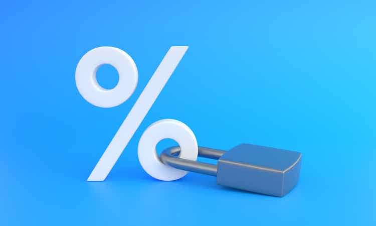 White percentage sign locked with keypad lock on a blue background with copy space