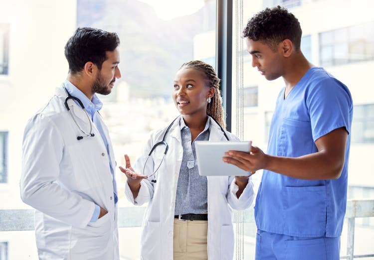 Shot of a group of doctors using a digital tablet at work