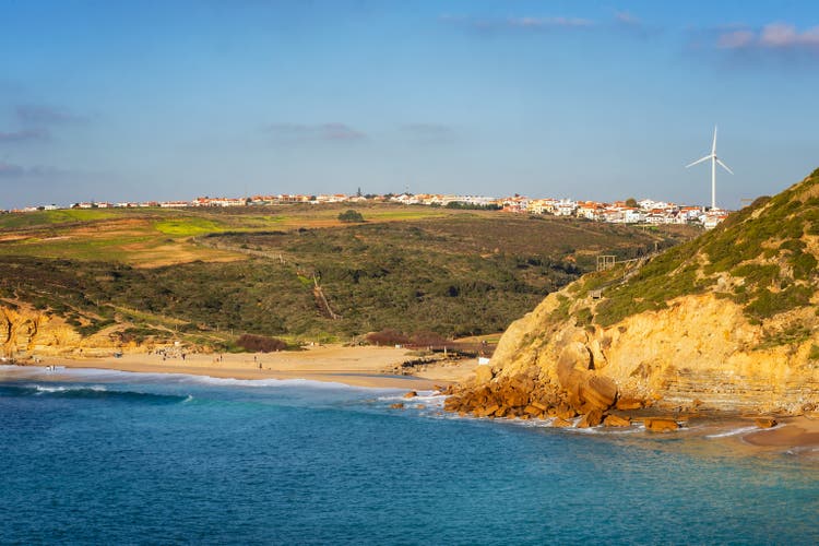 Ribeira dilhas beach in Ericeira with turquoise water on a sunny day, in Portugal