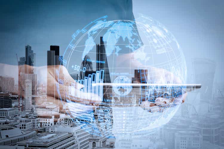 Double exposure of success businessman using digital tablet with london building and social media diagram