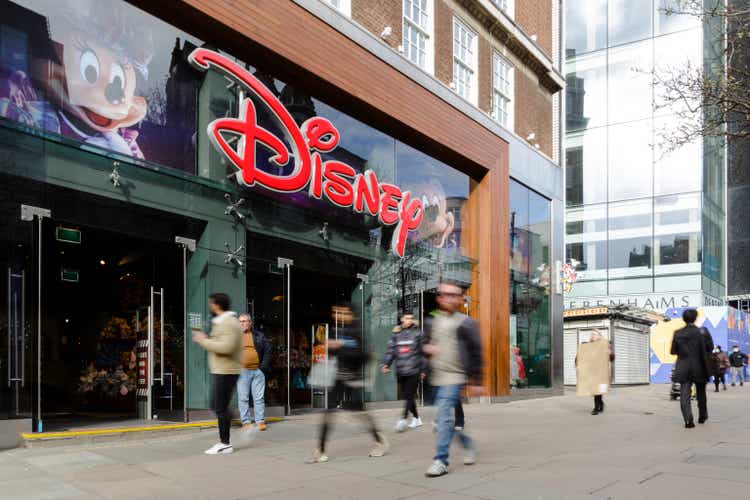 Exterior of Disney store with blurred motion of people on city street