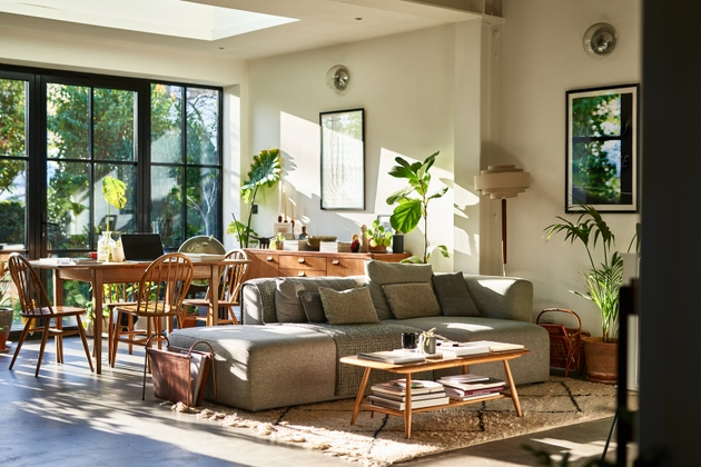 Open plan living space in residential house with natural light and retro furniture