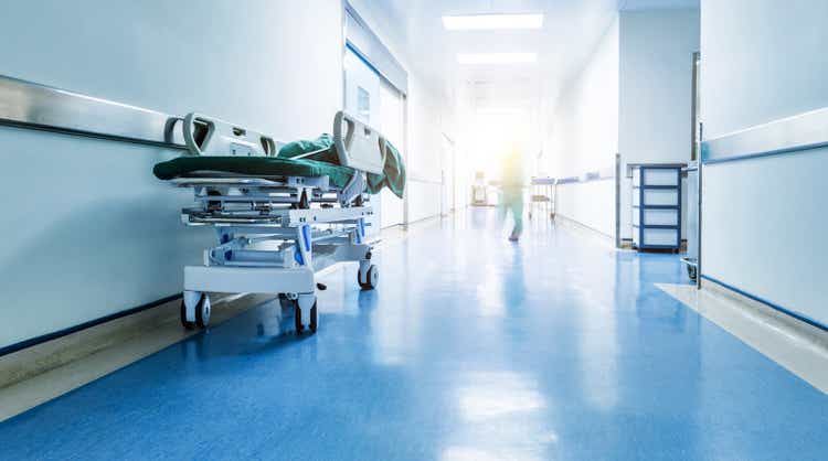 Doctors or nurses walking in hospital hallway, motion blurred