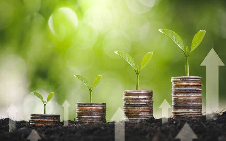 Seedling are growing on coins are stacked and the seedlings in Concept of finance And Investment of saving money or financial and business growth for profit