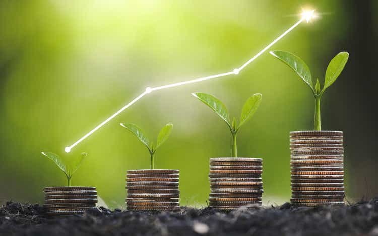 Seedlings grow on stacked coins and the seedlings in concept of finance and investment to save money or get financial and business growth for profit