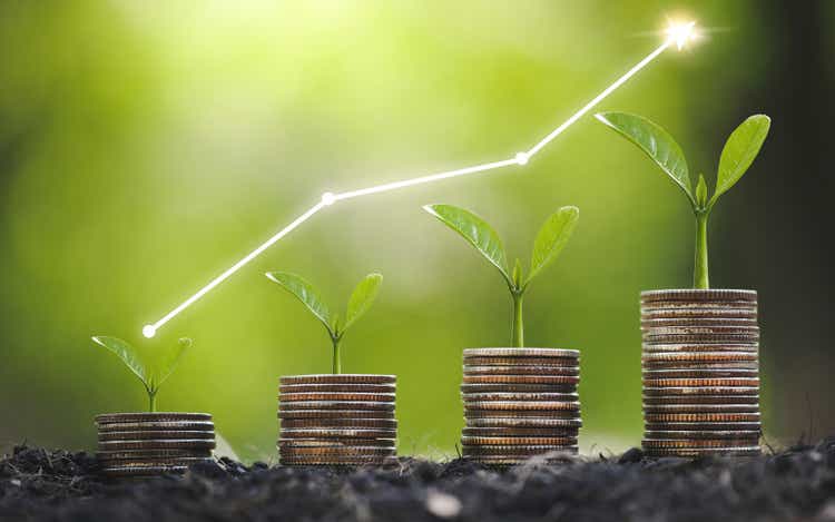 Seedling are growing on coins are stacked and the seedlings in Concept of finance And Investment of saving money or financial and business growth for profit