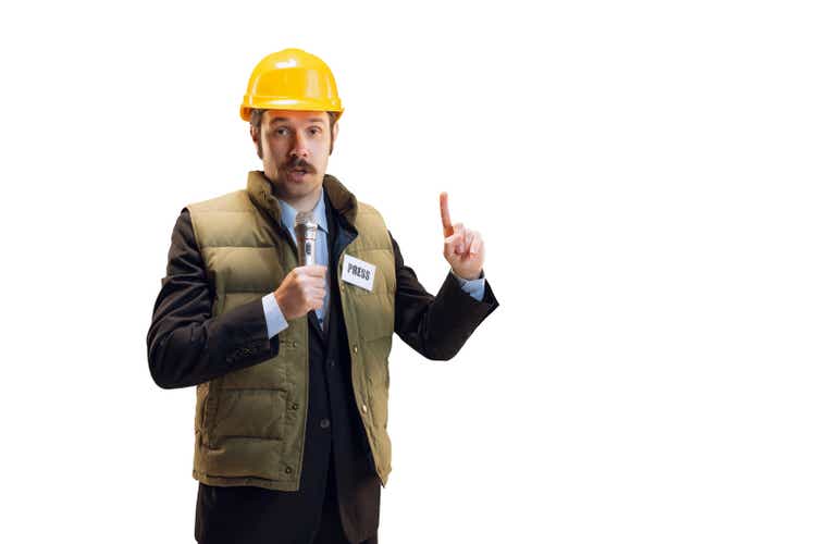 Portrait of young man in helmet, professional commentator, journalist with microphone broadcasting isolated over white background. News, emotions, job concept