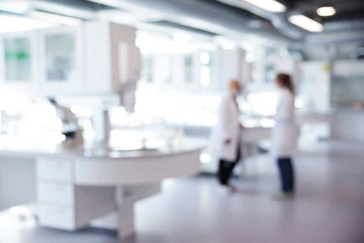 Defocused image of laboratory with two scientist