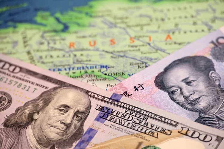 US dollar and Chinese yuan on the map of Russia
