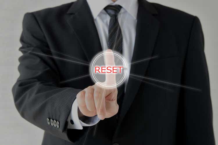 Business man puhing reset button