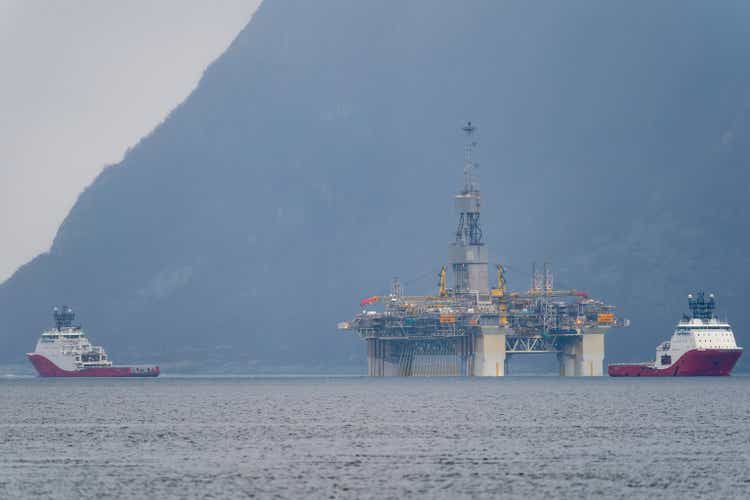 Rig move of Equinor oil platform Njord Alpha with offshore ahts vessels Siem Pearl and Siem Opal inside the Norwegian fjord.